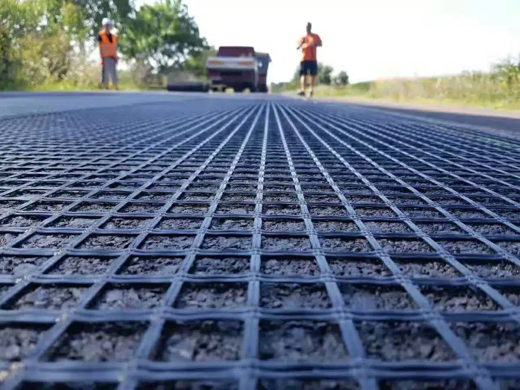 Geo grid mesh installation for soil stabilization and ground reinforcement at a construction site