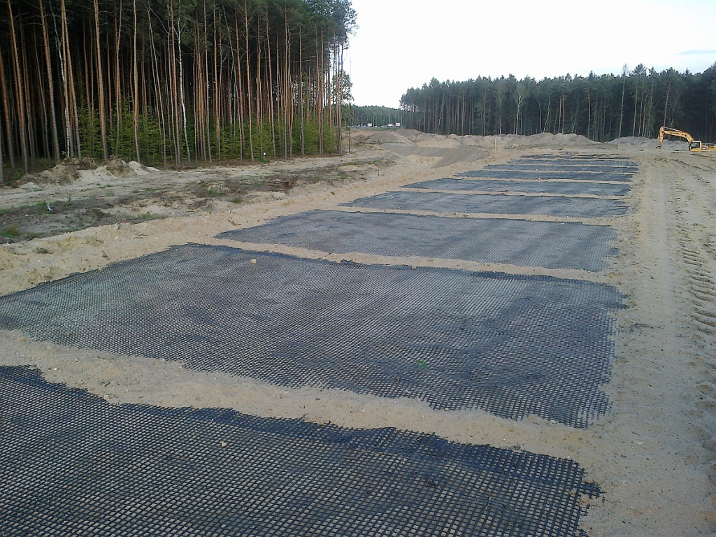 Geotextile for soil stabilization installed over a weak road subgrade before aggregate placement