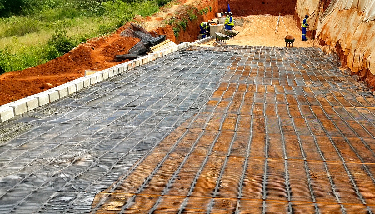 Permeable landscape parking area using Geogrid Grass Pavers, demonstrating reinforced soil structure, vegetation growth within grid cells, and sustainable stormwater management in garden engineering design.