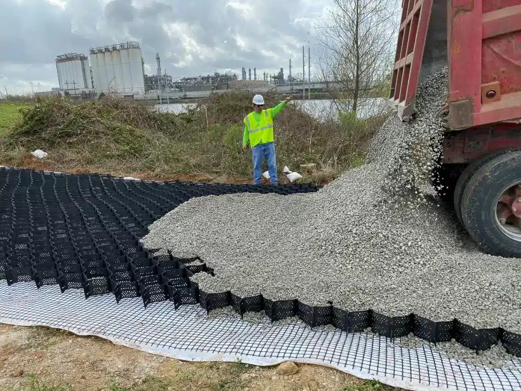 Geocell erosion control installation with HDPE cellular confinement panels being prepared for slope protection