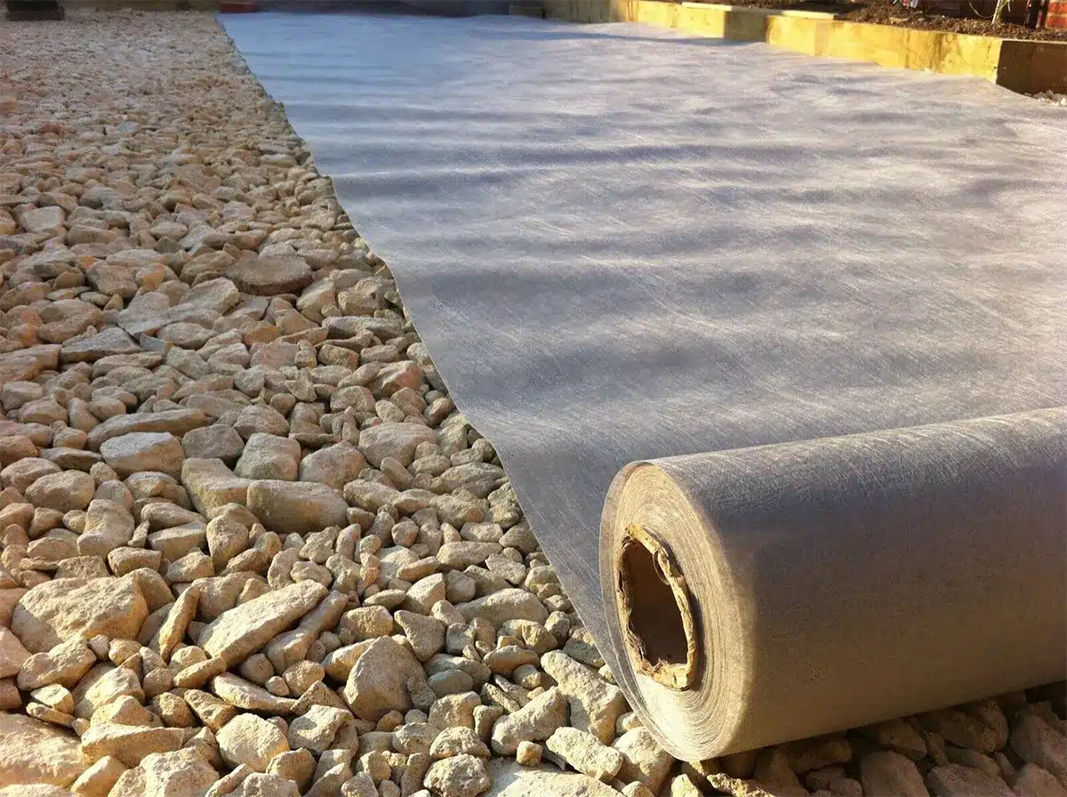 Geotextile fabric driveway installation for improved drainage and soil stabilization
