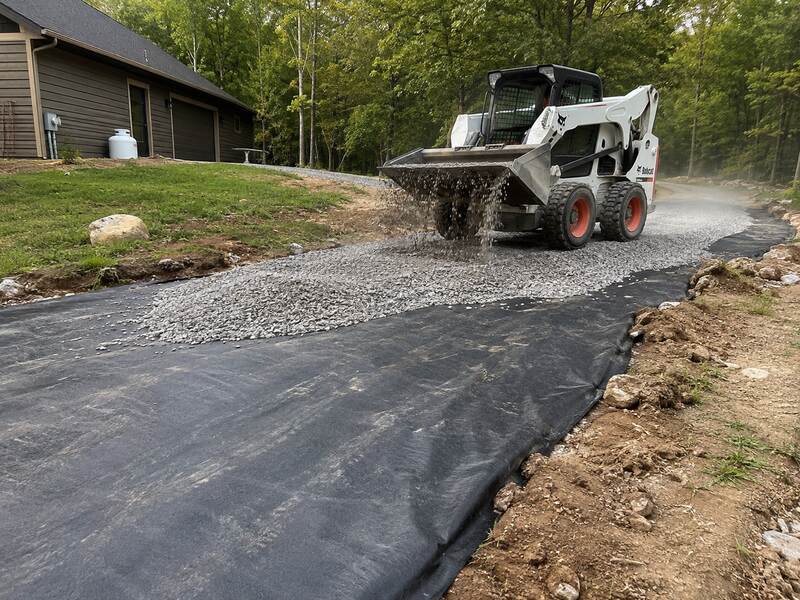 Geotextile stabilization fabric installed beneath aggregate for highway subgrade reinforcement and soil separation