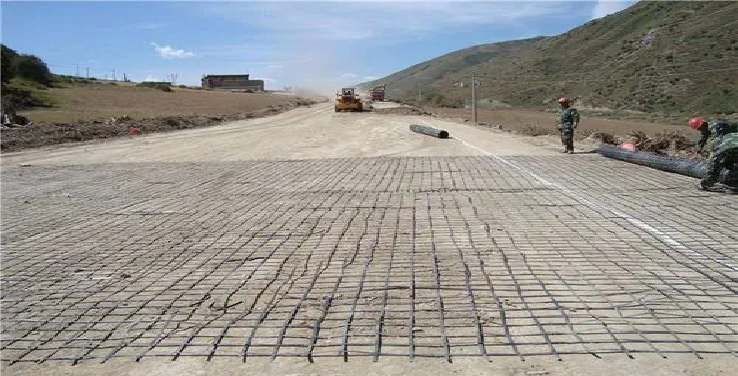 Installation of geogrid fabric for road reinforcement in civil engineering project