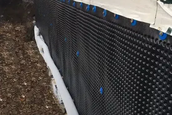 Installation of geocomposite drainage system in civil engineering project