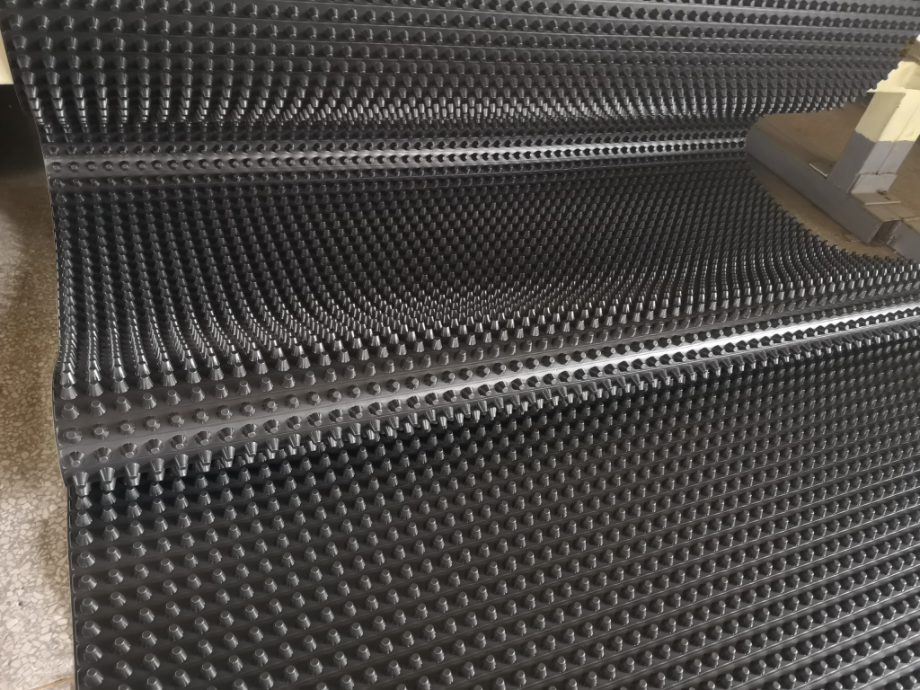 Sheet drain installation against building foundation wall for waterproofing and drainage
