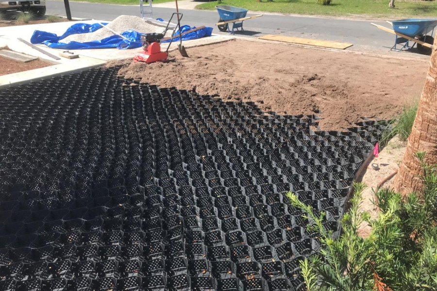 Geogrid mesh installation for stabilizing gravel driveways