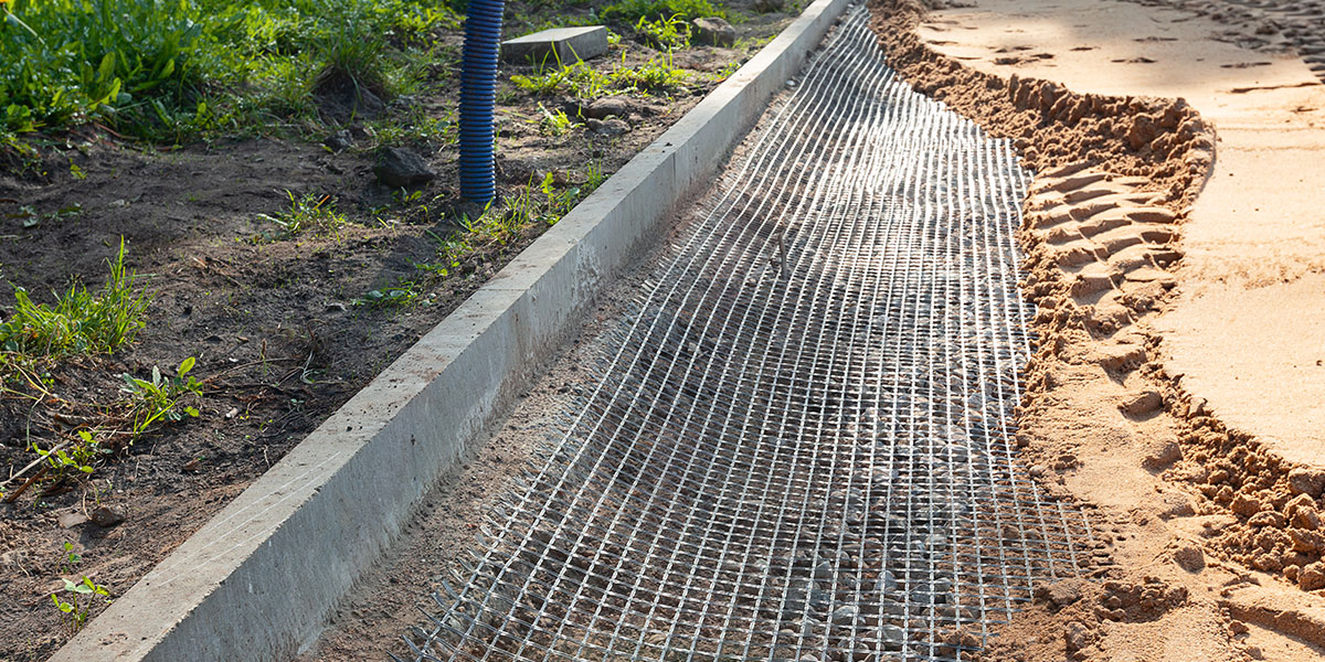 Highway retaining wall geocomposite drain installation for groundwater drainage
