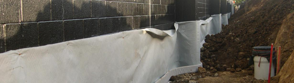 geocomposite wall drain installed behind retaining wall for efficient groundwater drainage