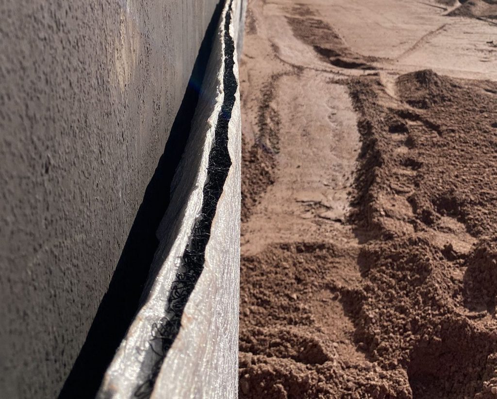 Geocomposite drainage layer installation for soil drainage and stabilization
