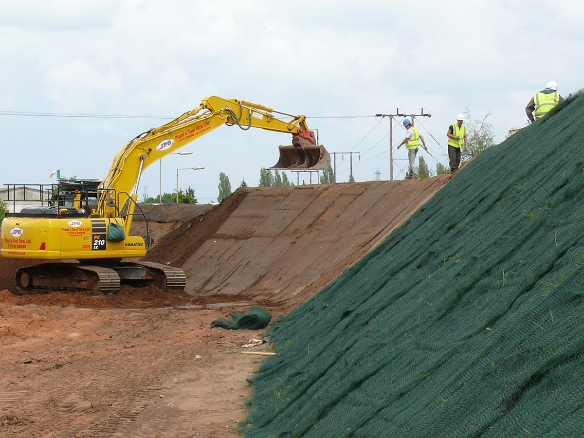 Railway embankment reinforced with geogrid reinforcement during construction