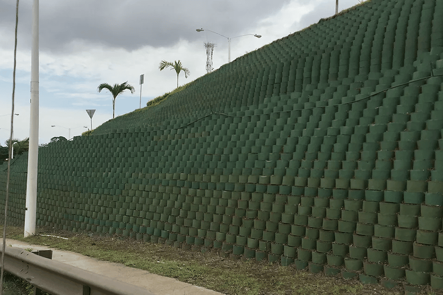 Geocomposite market drainage system installed behind a retaining wall for long-term soil stabilization