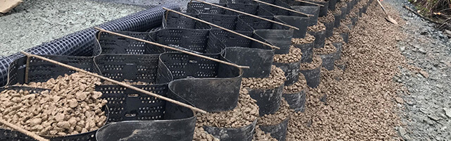 Geocell shed base ground stabilization system for parking lot construction