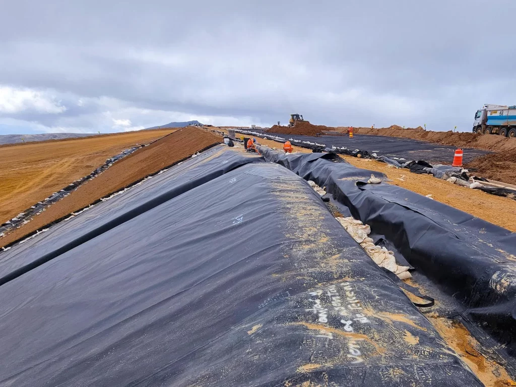Impermeable membrane HDPE geomembrane liner used in a mining heap leach pad for process solution containment