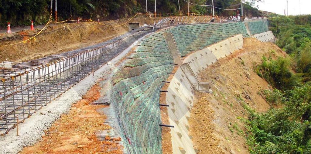 Geogrid for retaining walls installed in road embankment widening to improve soil reinforcement and lateral stability.