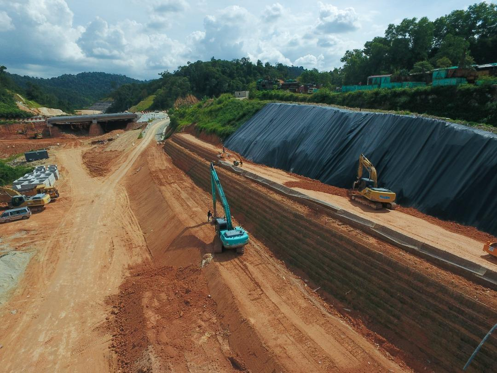 Geogrid for retaining walls used in highway widening to reinforce backfill and support road embankment stability.